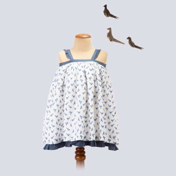 Mannequin image of strappy shoulder dress with blue bird print fabric bodice and in navy dot fabric straps
