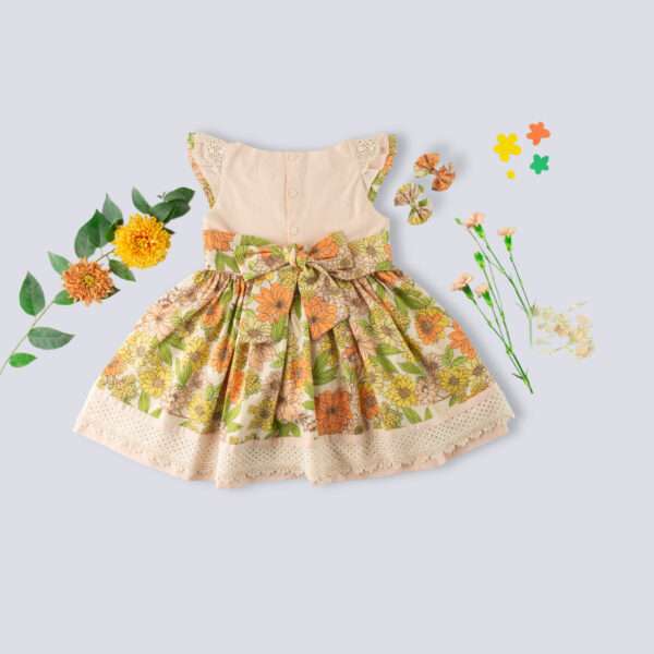 Rear image of floral cotton dress with a peach yoke and hem with beautiful lace trims and hand embroidery