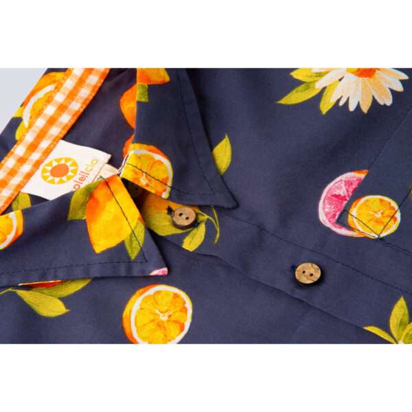 Close-up of navy fruit printed shirt featuring a classic collar, convenient pocket on the chest, and button-down front