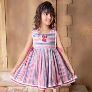 A little girl in sleeveless multi-color stripe dress with side ties, lace trims and a decorative thread bow
