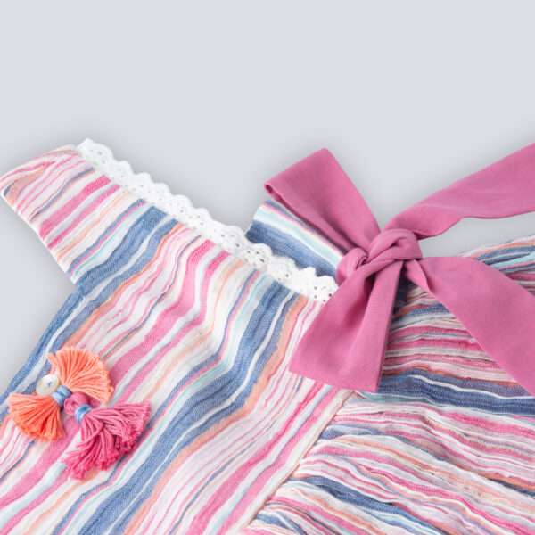 Close-up of sleeveless multi-color stripe dress with side ties, lace trims and a decorative thread bow