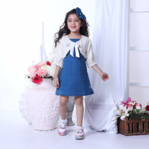 With a bright smile, a little girl enjoys wearing an ivory bolero jacket adorned with white ruffles