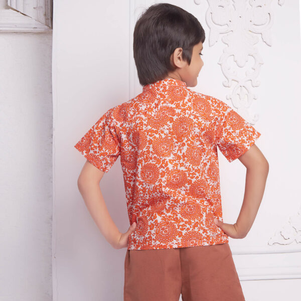 Back view of a boy wears an orange floral printed mandarin collared shirt matched with rust short