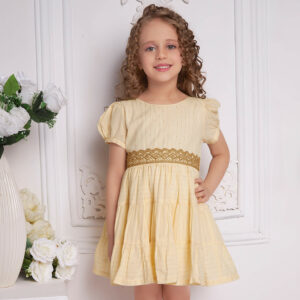 A girl in ivory beads dress with gold metallic lace at the waist
