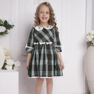 A girl laughing in tartan embroidered peter pan collared garment