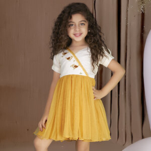 A mustard bird embroidered dress showcased by a young girl, featuring delicate sequin embellishments