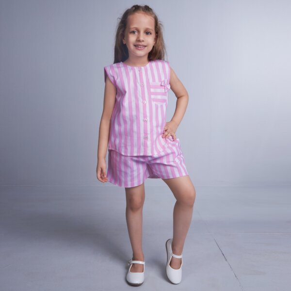 A girl in pink stripes co-ords set with bow detail, front fastened by buttons