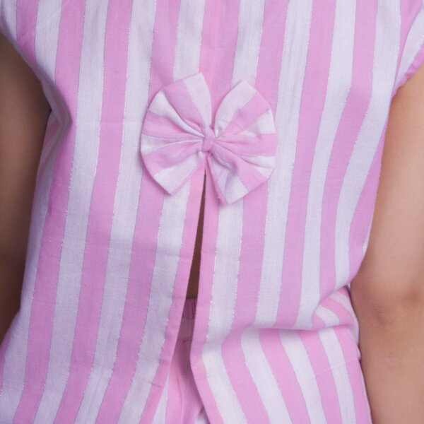 A detailed close-up of a girl seen from the back, wearing a pink sleeveless blouse with a slit at the back adorned with a bow