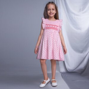 In a long picture, a model wears pink heart embroidered smock dress