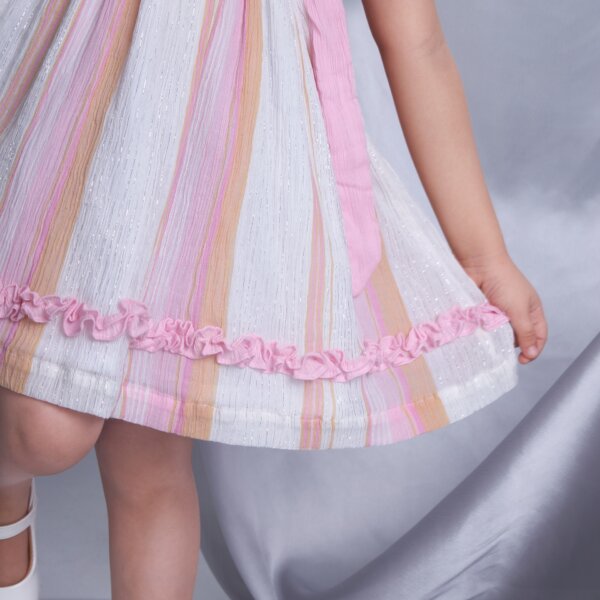 Detailed closeup of the ruffle in a sleeveless pink lurex embroidered dress