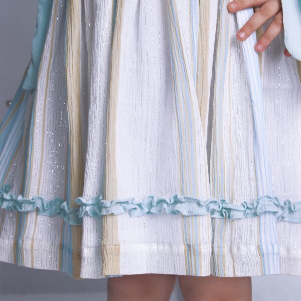 Detailed closeup of the ruffle in a sleeveless blue lurex embroidered dress with side ties