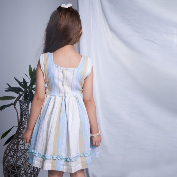 Back view of a girl in blue lurex dress with side ties
