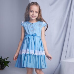 A girl posing in blue ombre embroidered dress with lace embellishment
