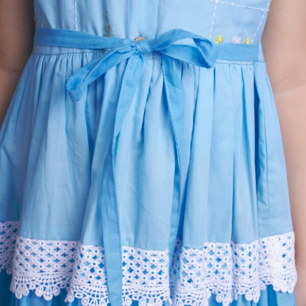 Closeup picture of the blue ombre embroidered dress with front wood buttons and a tie-up sash