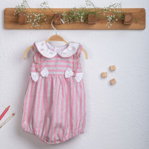 Hand-embroidered pink striped peter pan collared baby girl onesie hanging on a hanger.