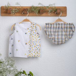 Hand-embroidered and floral-printed jabla paired with checked bloomer from Soleilclo, hanging on hangers.